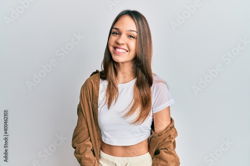 Fotografie Young brunette woman wearing casual clothes with a happy and cool smile on face