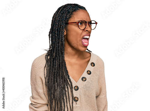 African american woman wearing casual clothes angry and mad screaming frustrated and furious, shouting with anger. rage and aggressive concept.