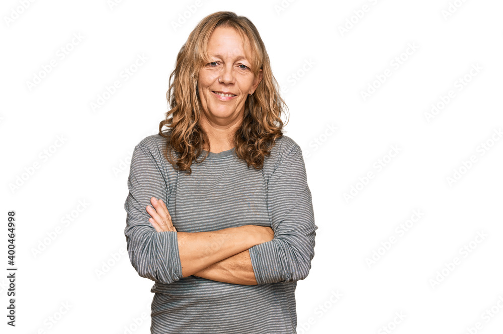 Middle age blonde woman wearing casual clothes happy face smiling with crossed arms looking at the camera. positive person. Middle age blonde woman wearing casual clothes happy face smiling with crossed arms looking at the camera. positive person.