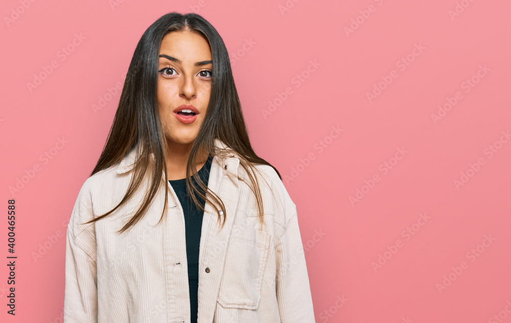 Beautiful hispanic woman wearing casual clothes scared and amazed with open mouth for surprise, disbelief face