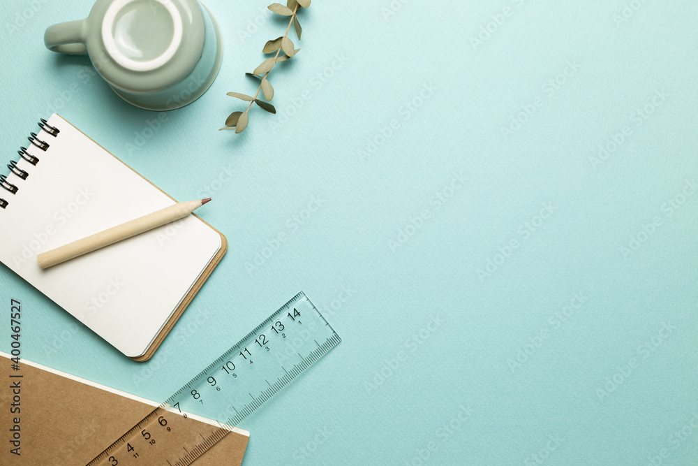 Notebook, mug cup, pencil, ruler on sky blue background. flat lay, top view, copy space. Work and study place Notebook, mug cup, pencil, ruler on sky blue background. flat lay, top view, copy space. Work and study place