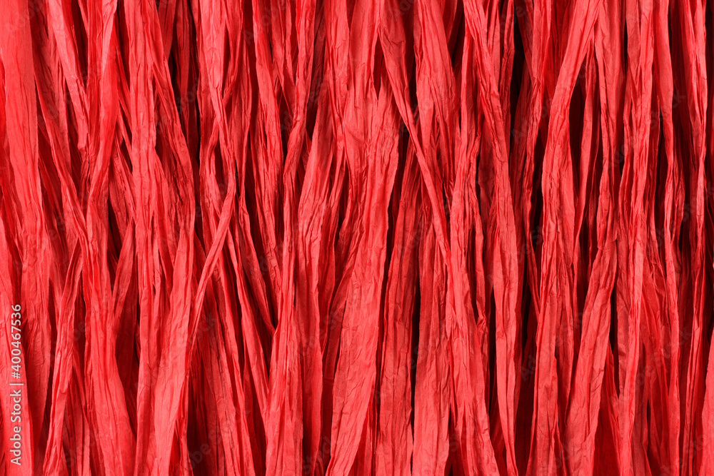 Background - red paper raffia strips situated in parallel lines.