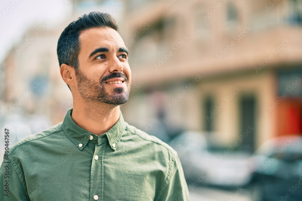 Young hispanic man smiling happy standing at the city. Young hispanic man smiling happy standing at the city.