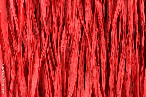 Fotografie Background - red paper raffia strips situated in parallel lines.