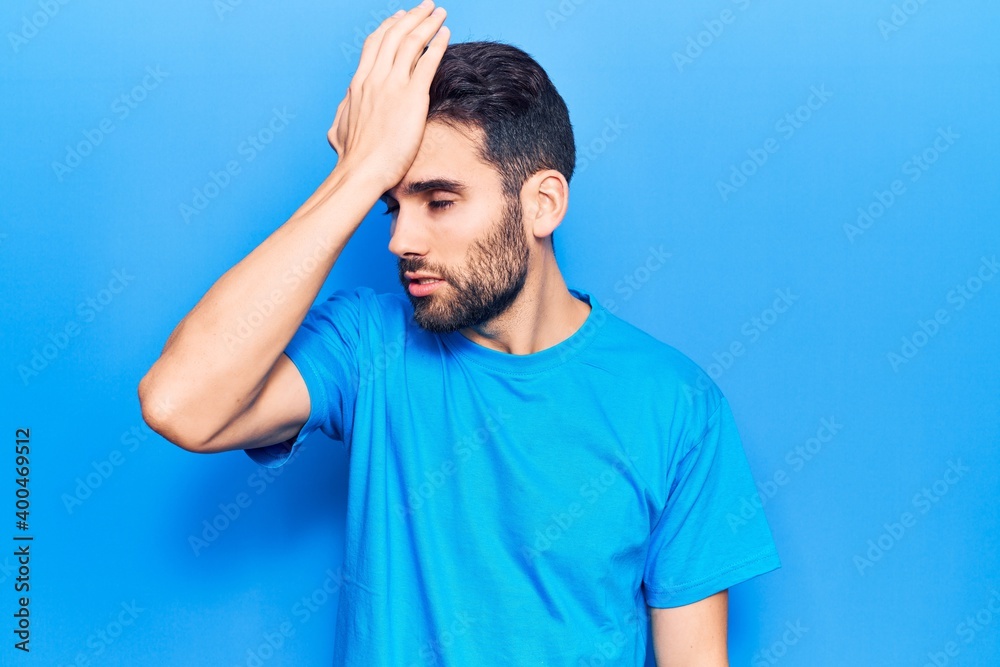 Young handsome man with beard wearing casual t-shirt surprised with hand on head for mistake, remember error. forgot, bad memory concept. Young handsome man with beard wearing casual t-shirt surprised with hand on head for mistake, remember error. forgot, bad memory concept.