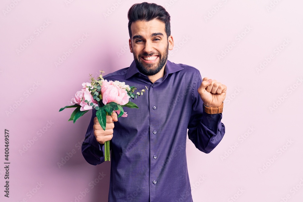 Young handsome man with beard holding bouquet of flowers screaming proud, celebrating victory and success very excited with raised arm Young handsome man with beard holding bouquet of flowers screaming proud, celebrating victory and success very excited with raised arm