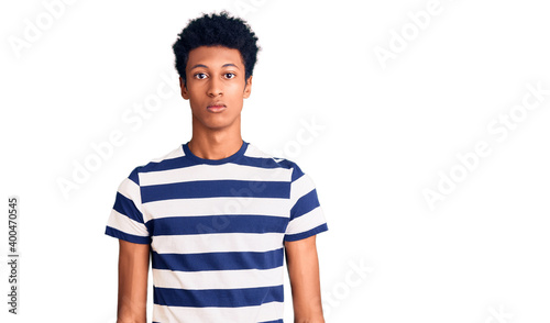 Young african american man wearing casual clothes relaxed with serious expression on face. simple and natural looking at the camera.