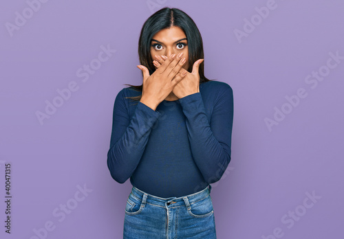 Young latin transsexual transgender woman wearing casual clothes shocked covering mouth with hands for mistake. secret concept.