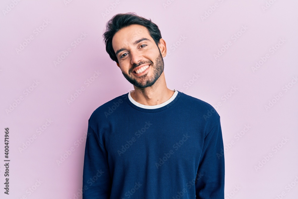 Fototapeta premium Young hispanic man wearing casual clothes with a happy and cool smile on face. lucky person.