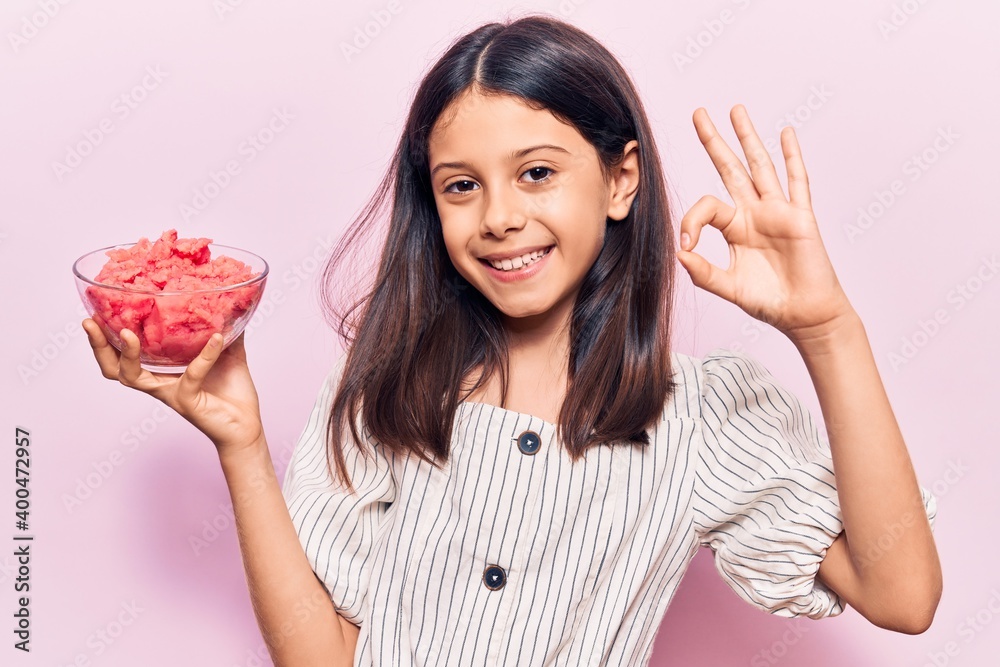 Beautiful child girl holding ice cream doing ok sign with fingers, smiling friendly gesturing excellent symbol Beautiful child girl holding ice cream doing ok sign with fingers, smiling friendly gesturing excellent symbol