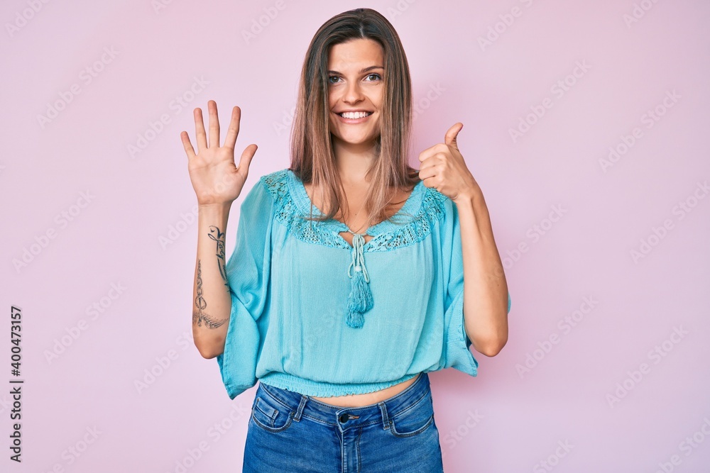 Beautiful caucasian woman wearing casual clothes showing and pointing up with fingers number six while smiling confident and happy. Beautiful caucasian woman wearing casual clothes showing and pointing up with fingers number six while smiling confident and happy.