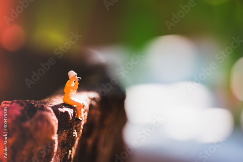 Miniature people  woman sitting on blurry background using for holiday concept