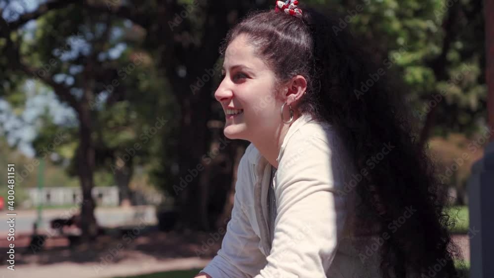 young woman walking in park. happy smile talking young woman walking in park. happy smile talking