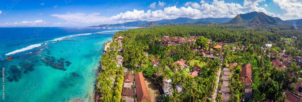 An aerial panoramic image of Candidasa shoreline on Bali island in Indonesia