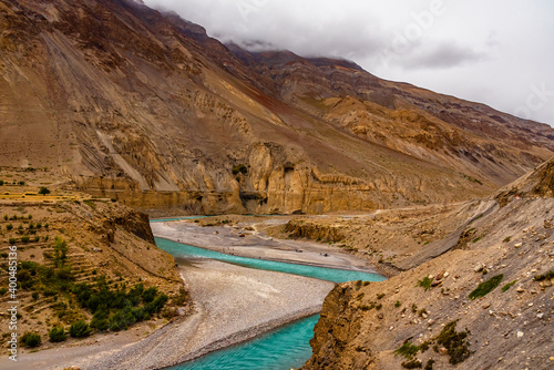 Meander is one of a series of regular sinuous curves in a river, produced by river as it erodes the sediments from outer concave cut bank and deposits sediment downstream on an inner convex bank.