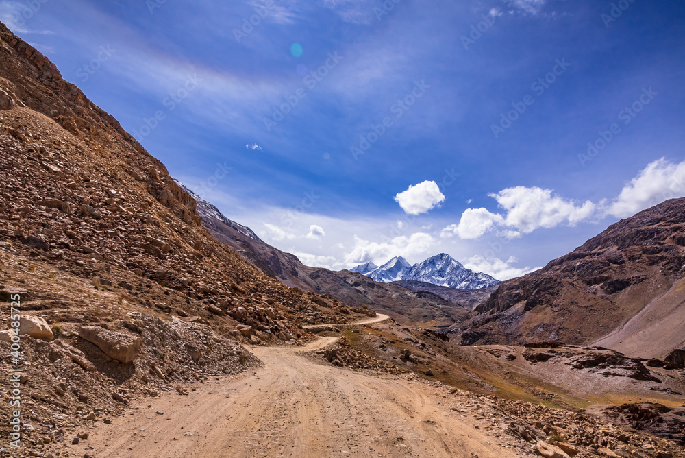 Beautiful view of cold desert arid landscape enroute off road connecting Kaza town with Chandratal Lake passing through Kunnzum Pass in Lahaul Spiti region of Himalayas in Himachal Pradesh, India.