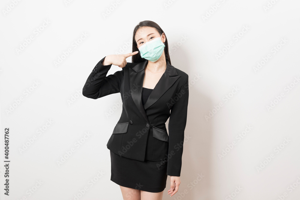 Portrait young Asian business woman in suit wearing face mask on white isolated background. Portrait young Asian business woman in suit wearing face mask on white isolated background.