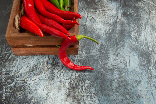 front view colored spicy peppers on a dark-light background pepper ripe photo salad