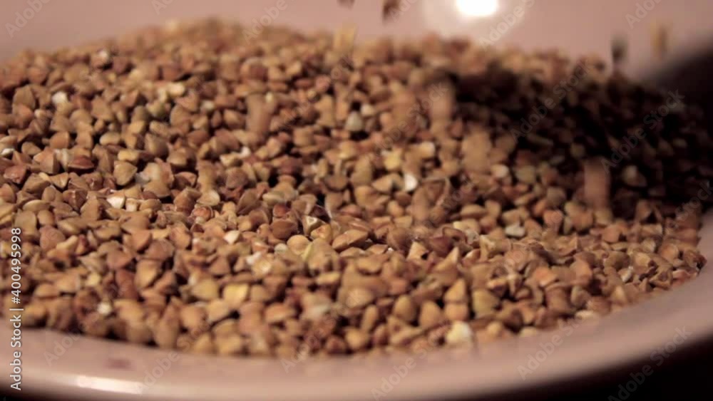 spoon into the raw buckwheat porridge. The concept of healthy eating, vegetarianism spoon into the raw buckwheat porridge. The concept of healthy eating, vegetarianism
