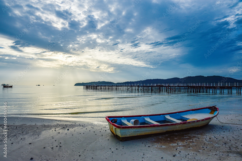 beautiful landscape of the blue sky, wooden boat, wooden bridgeon the Kohrong Samloem beach at Cambodia