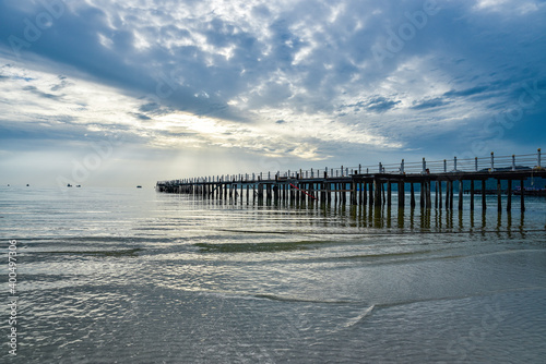 beautiful landscape of the blue sky, wooden boat, wooden bridgeon the Kohrong Samloem beach at Cambodia photo