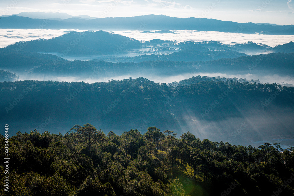 Beautiful Landscape of mountain layer in morning sun ray and winter fog at Dalat city, Vietnam