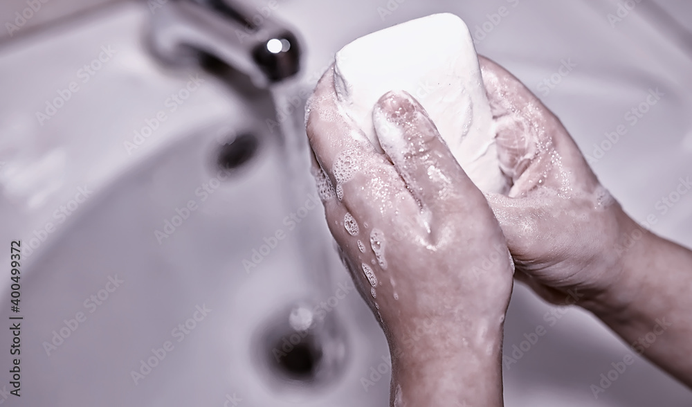 Fototapeta premium Hygiene rules. Hand washing before meals. Antibacterial treatment of hands with soap. A way to prevent virus infection. Coronavirus protection.