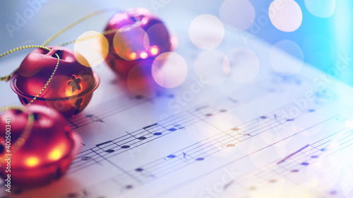 Fotografie Christmas carol with jingle bells and candles