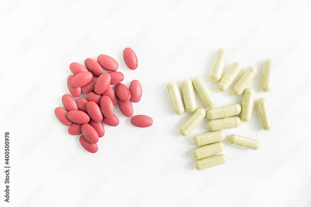 Red and yellow tablets Placed on white background Medicines help keep the body normal. Red and yellow tablets Placed on white background Medicines help keep the body normal.