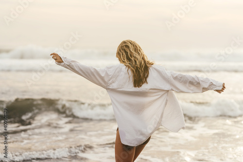 Young female enjoying sunny day on tropical beach Bali Indonesia