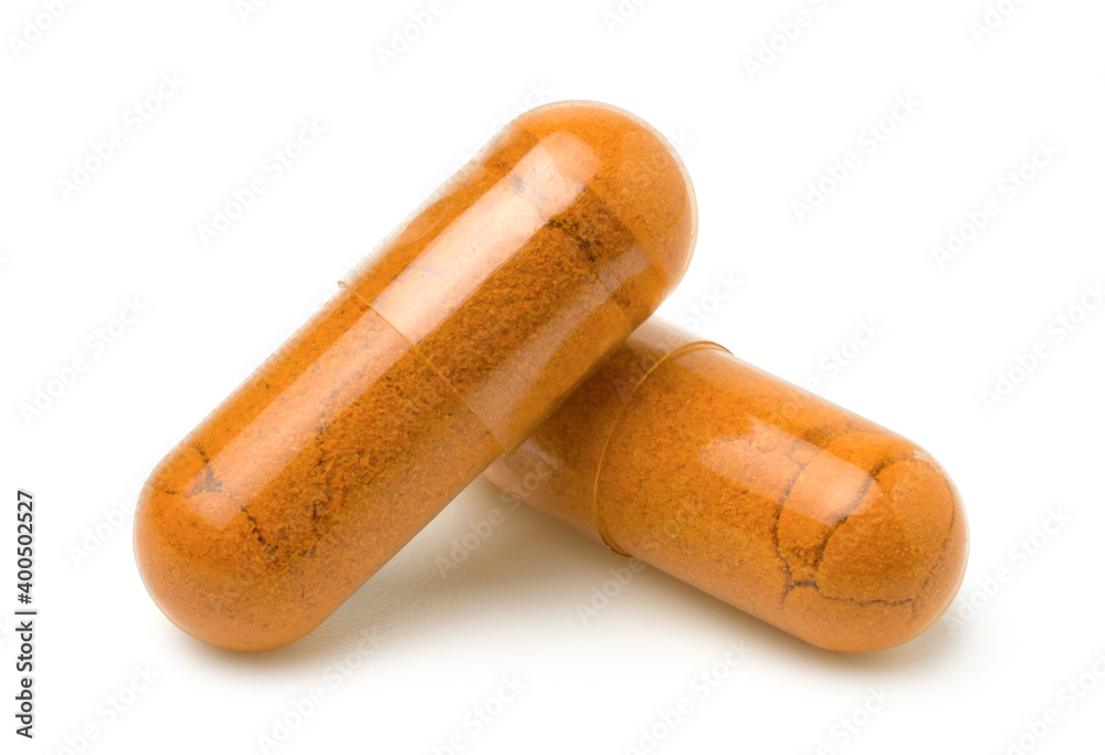 Close up of two turmeric capsules (Herbal capsules) isolated on white background,with clipping path. Close up of two turmeric capsules (Herbal capsules) isolated on white background,with clipping path.
