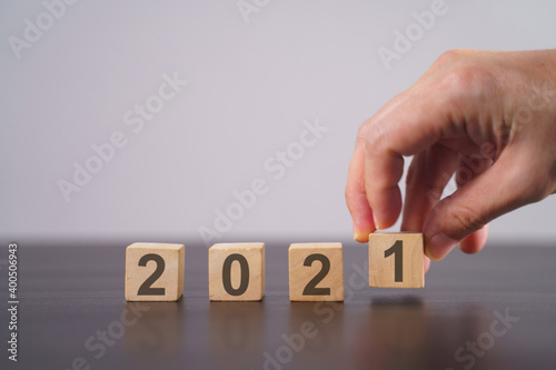 Text 2021 on wooden cube isolated over background.