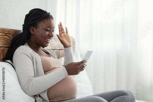 Online Communication. Black Pregnant Lady Making Video Call With Smartphone At Home