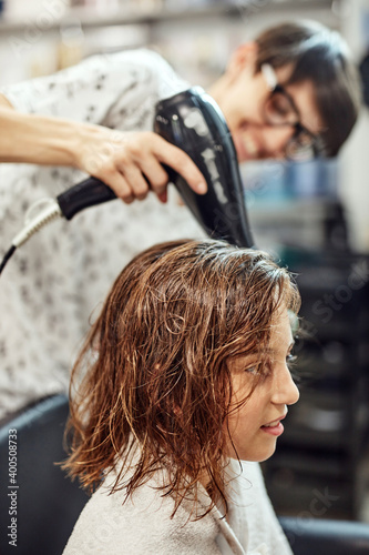 Hairdresser cutting hair in a salon.
