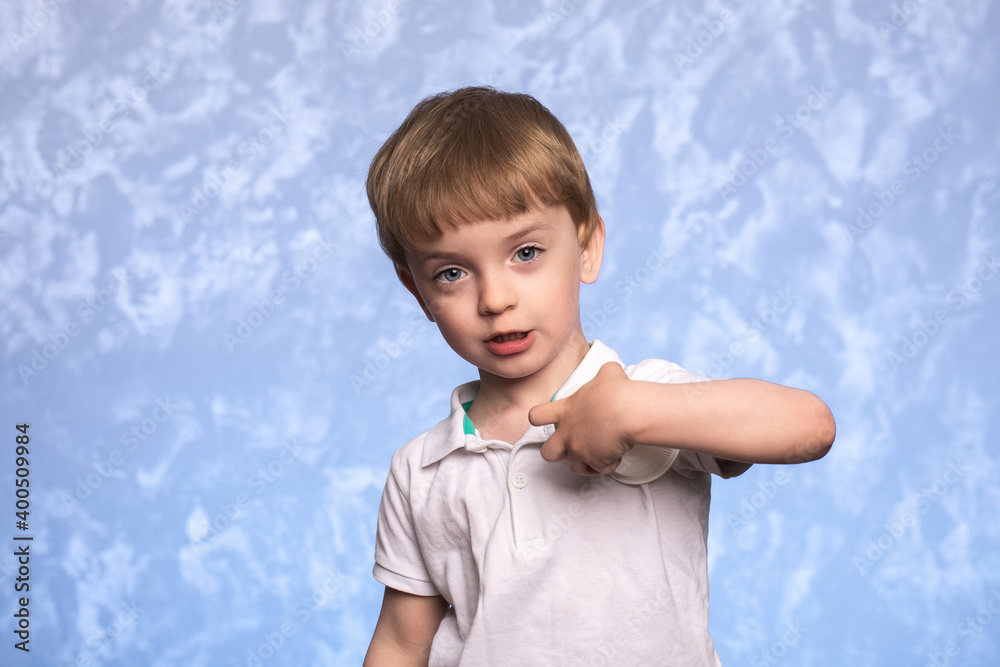 portrait of a little three-year-old boy on a blue background. Close-up of a child of European appearance. portrait of a little three-year-old boy on a blue background. Close-up of a child of European appearance.