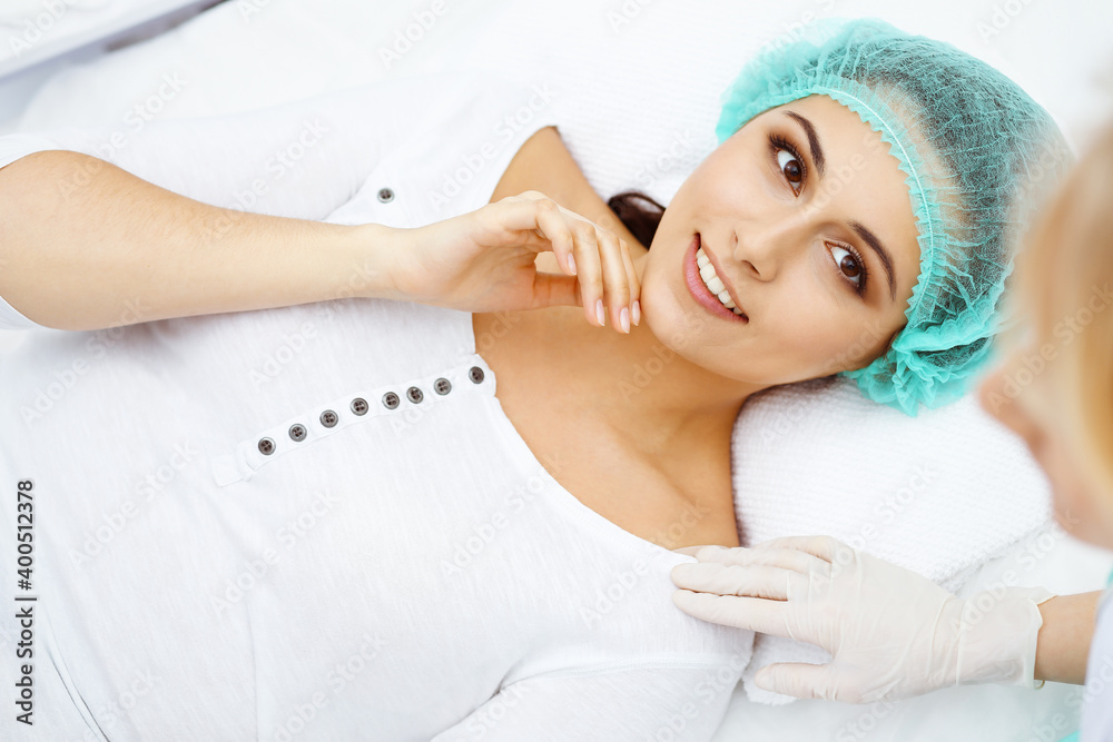 Professional cosmetologist making injection in face, lips. Young woman gets syringe with filler for face contouring or augmentation. Face aging, rejuvenation and hydration procedures Professional cosmetologist making injection in face, lips. Young woman gets syringe with filler for face contouring or augmentation. Face aging, rejuvenation and hydration procedures