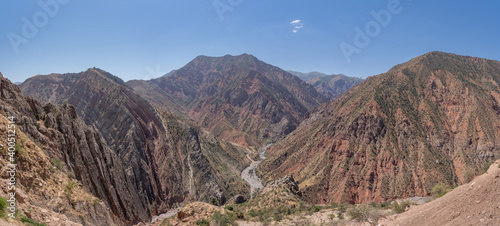 Landscape panorama of colorful red mountains with dry river bed in Khatlon province of Tajikistan photo