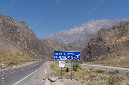 Road sign to Afghanistan with some humor added in the Panj river valley, Darvaz district, Gorno-Badakshan, the Pamir mountain region of Tajikistan