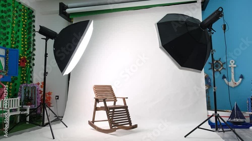 Photo or video studio with two hexagone studio lights. White screen and rocking chair