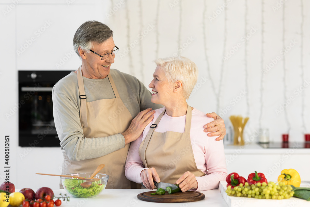 Happy Senior Spouses Cooking Making Salad Standing In Kitchen Indoors Happy Senior Spouses Cooking Making Salad Standing In Kitchen Indoors