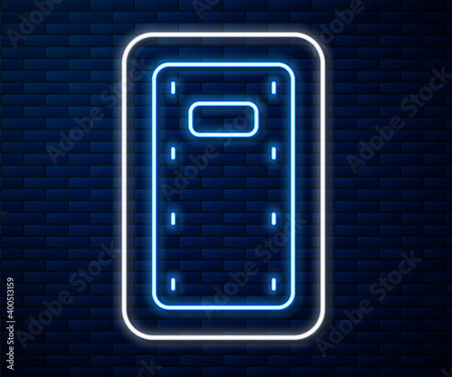 Glowing neon line Military assault shield icon isolated on brick wall background.  Vector.