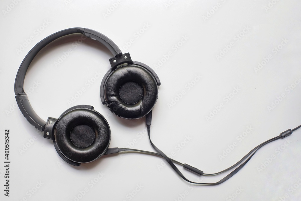 Black headphones with the casual model isolated on white Black headphones with the casual model isolated on white