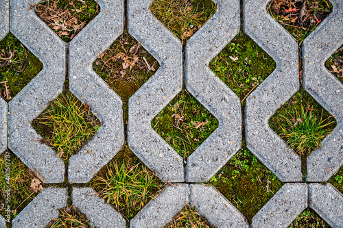A top view shot of checkered tiles of a garden path