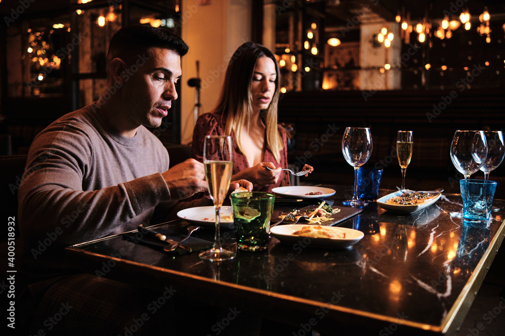 Young couple on a date at the restaurant. Young couple on a date at the restaurant.