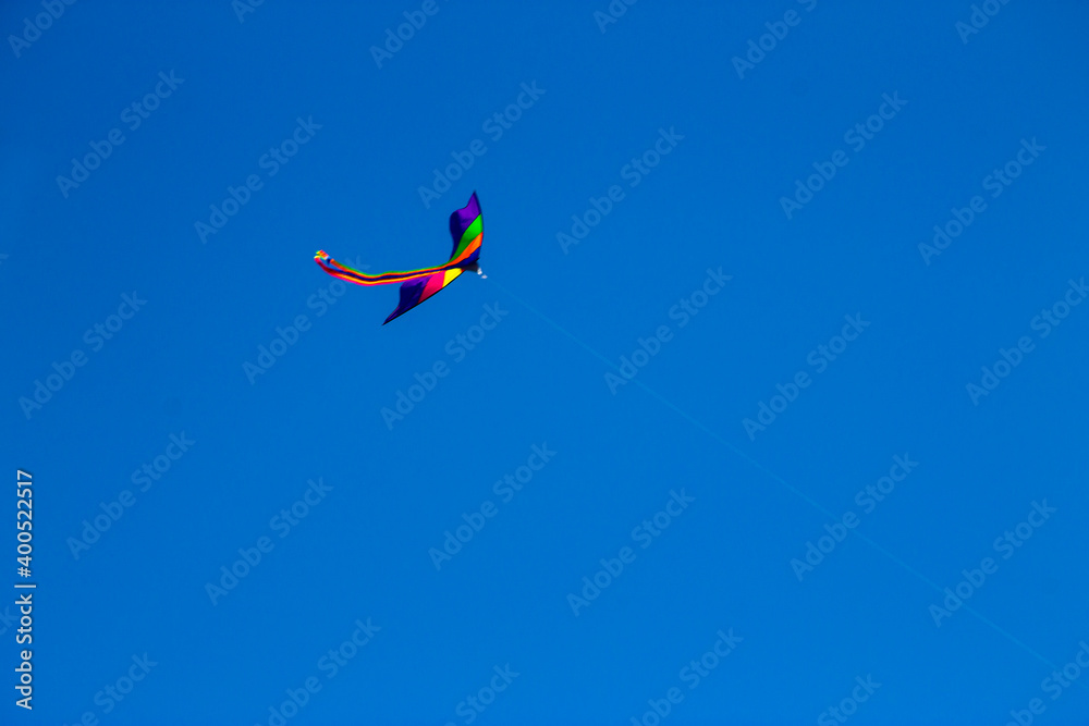 Colorful flying kite fly in the blue sky Colorful flying kite fly in the blue sky