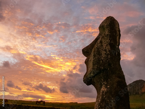 Statues of Easter Island in the background of the sunset. melting of the Easter statue in the sunlight of the sunset. photo