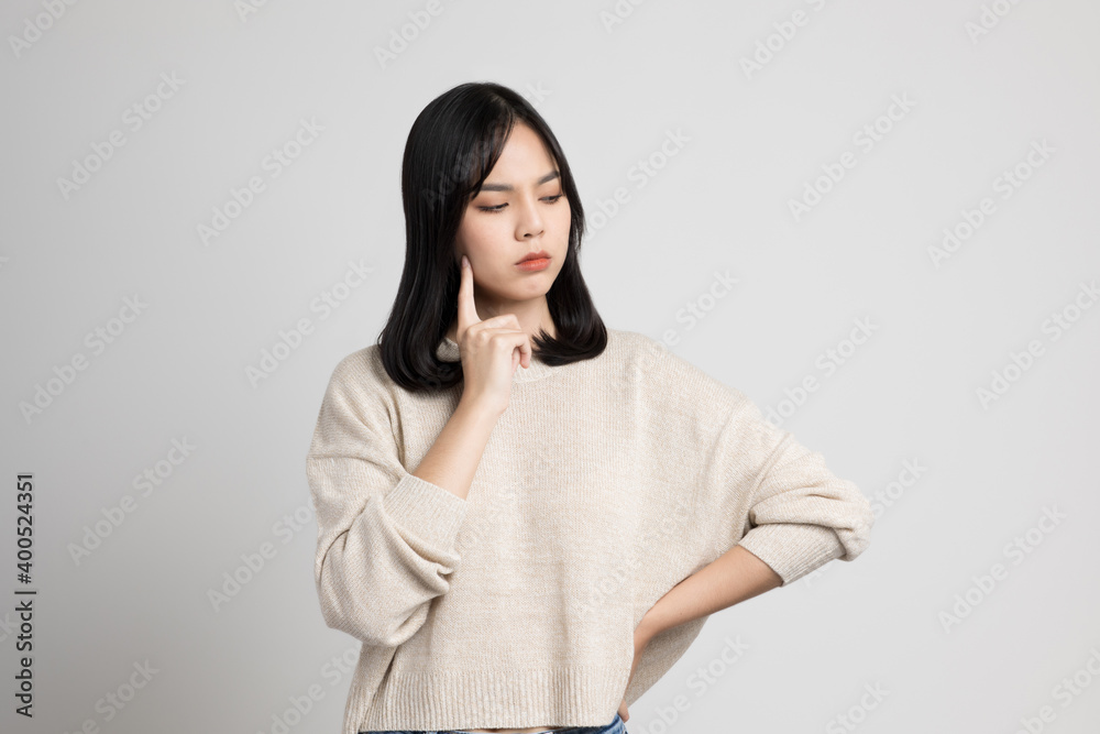 Asian female standing and thinking on isolated white background. Asian female standing and thinking on isolated white background.
