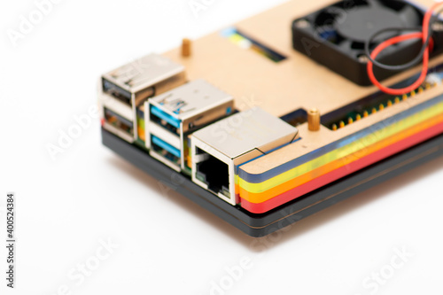 Focused USB 3.0 and RJ-45 connectors, defocused remainder of the microboard computer in multi-colored case