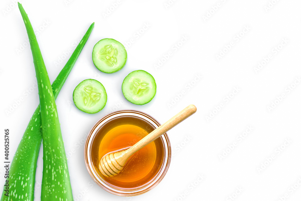 Aloe vera lesf with cucumber and honey isolated on white background. Natural medicine plant, beauty spa and skin care concept. Top view. Flat lay. Aloe vera lesf with cucumber and honey isolated on white background. Natural medicine plant, beauty spa and skin care concept. Top view. Flat lay.