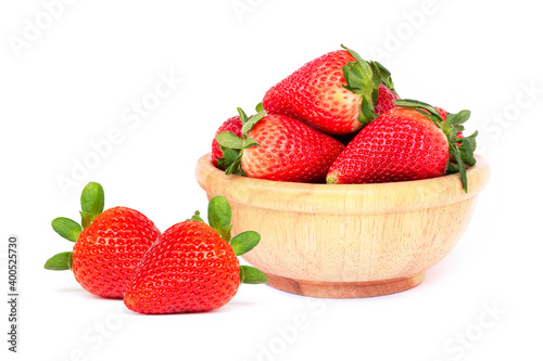 Strawberries in wooden bowl and isolated on white background.